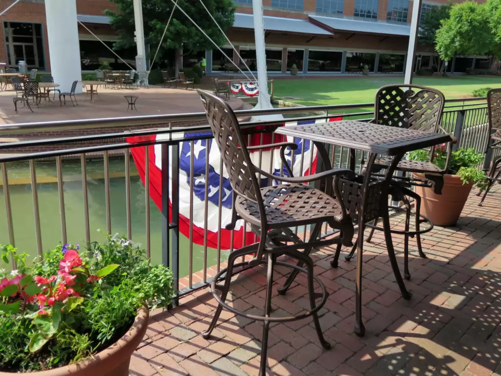 Flower pots and chairs near the stage.