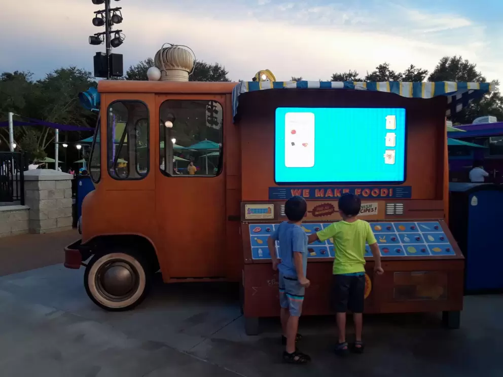 Boys play the imaginary pizza game at Sesame Street.
