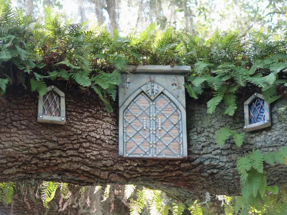 Castle fairy doors on a thick tree limb, 2019 special exhibit.