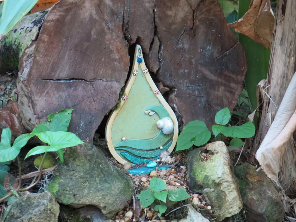 Fairy door with wave and shell.