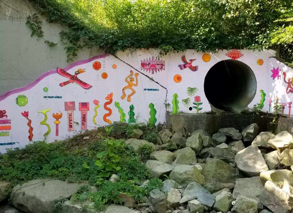 Bolin Creek Trail near Umstead Park, with its decorated drain.