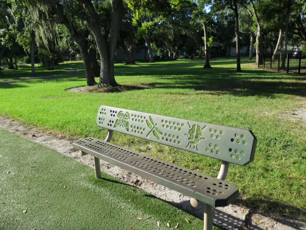 Park bench with insect cutouts.