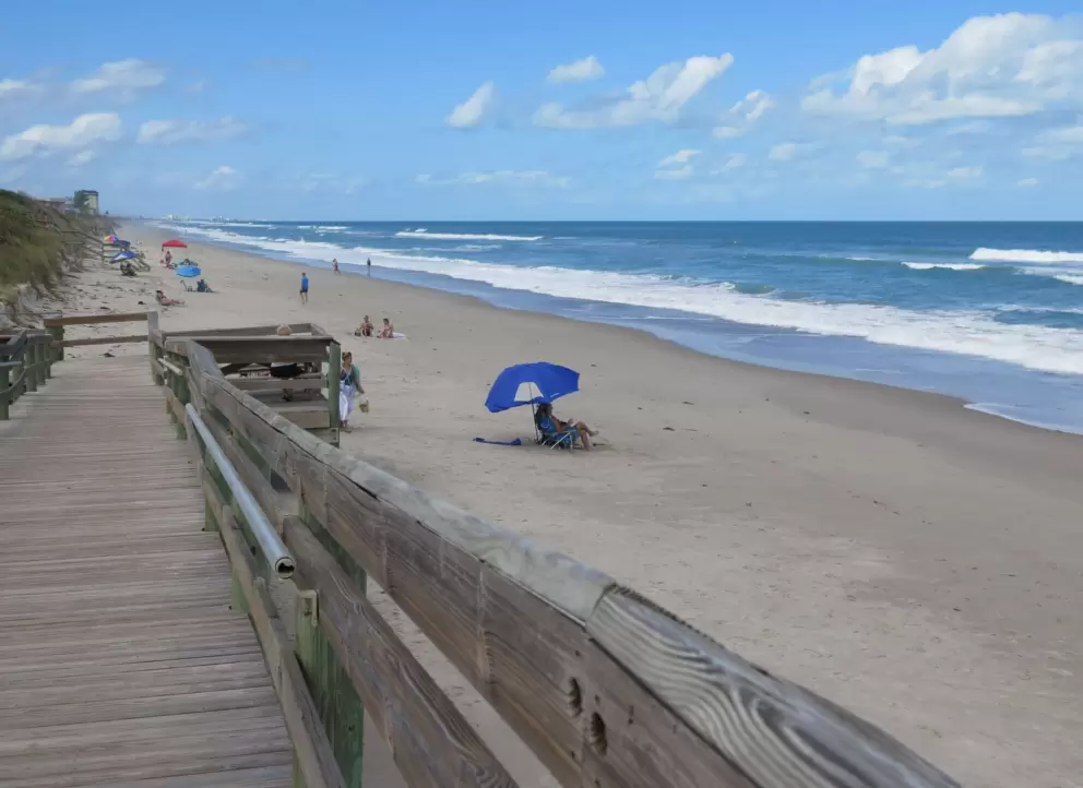 Walk down the wooden boardwalk to the sand.