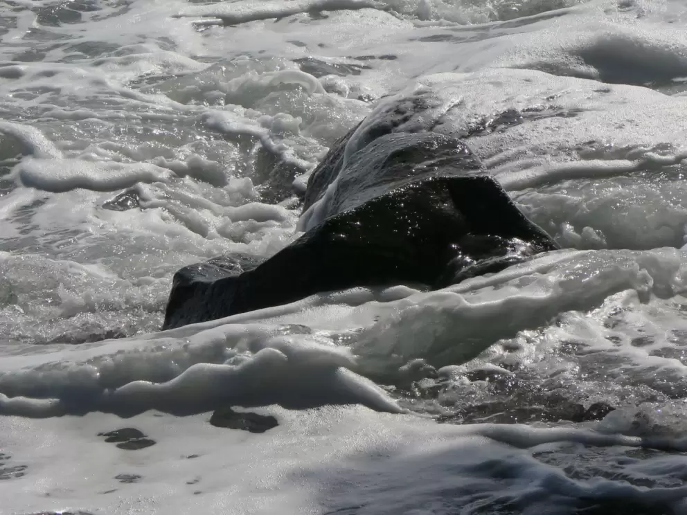 Creamy waves over a rock.