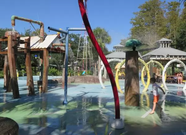 Boy running in the splash pad.