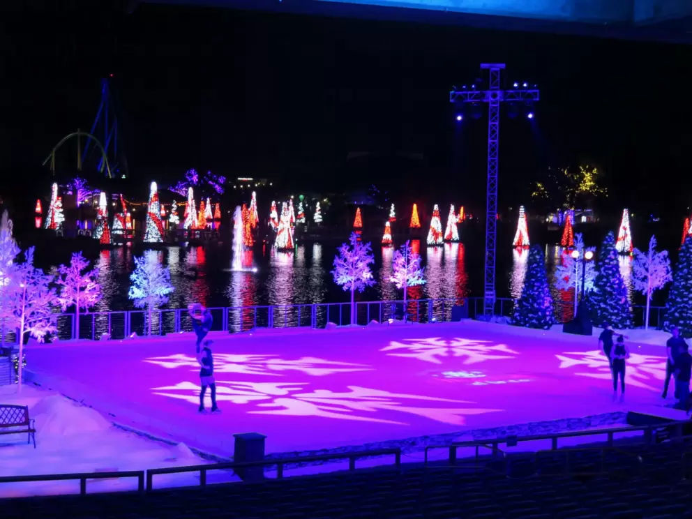 Ice skating show at the end of day at Christmastime.