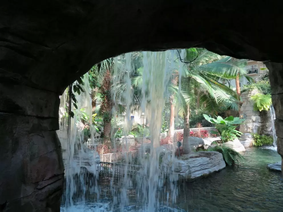 Waterfall through a rock arch.