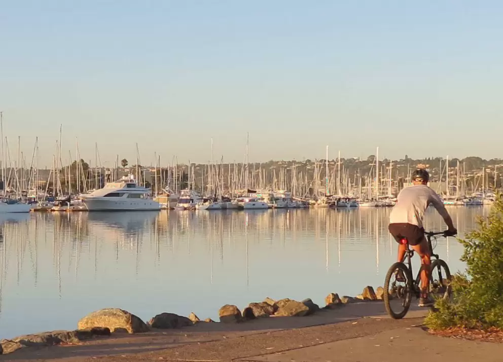 Bike rider checking out the boats.