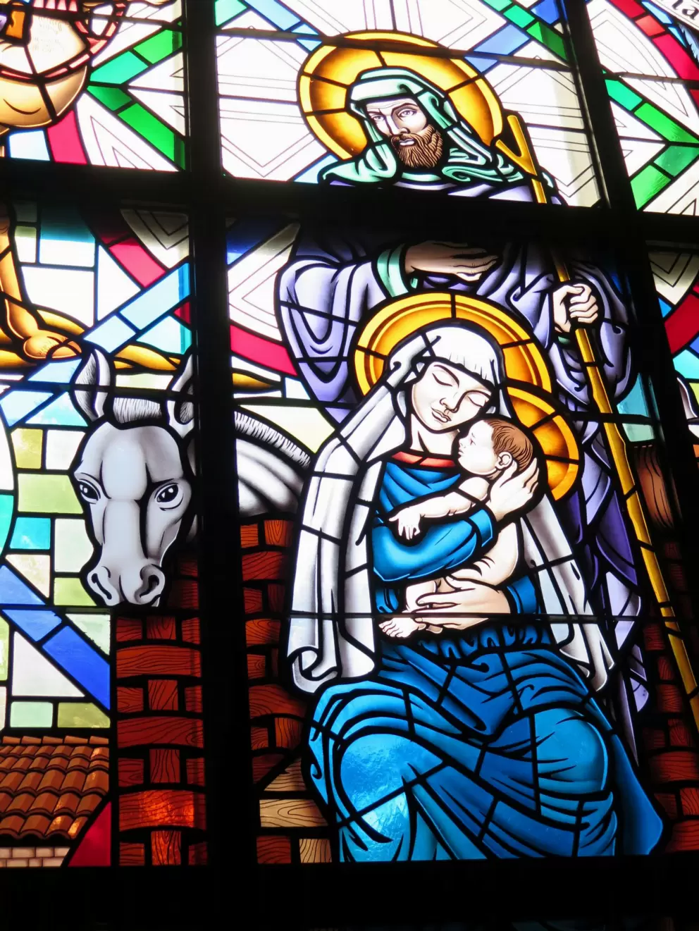 Mary, Joseph, and Jesus, in stained glass.