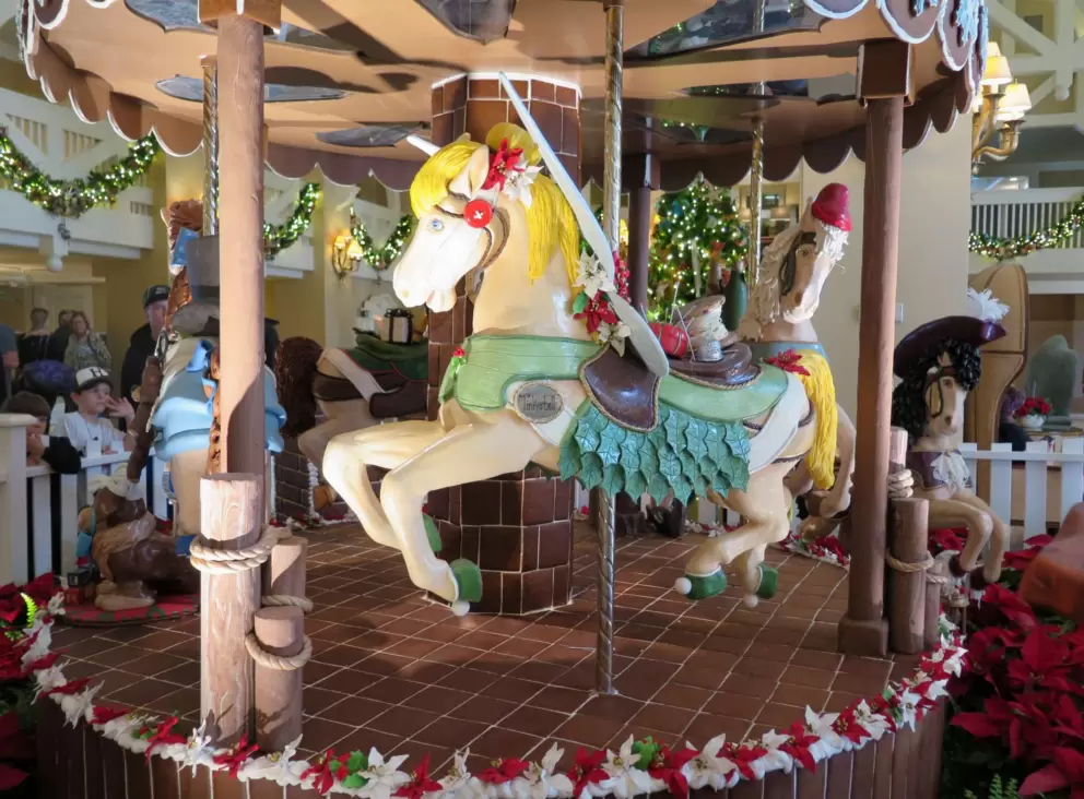Yellow horse in gingerbread carousel at Beach Club Resort. It goes round and round.