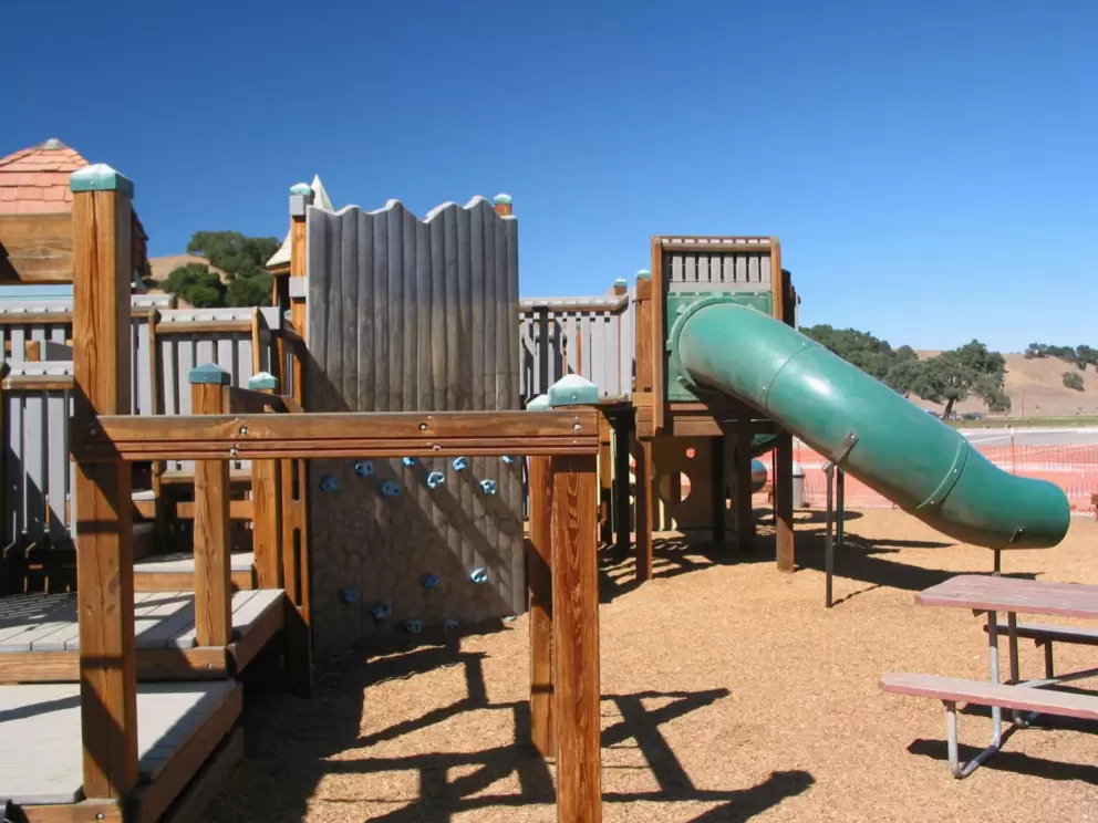 Tube slide amidst other fun structures.