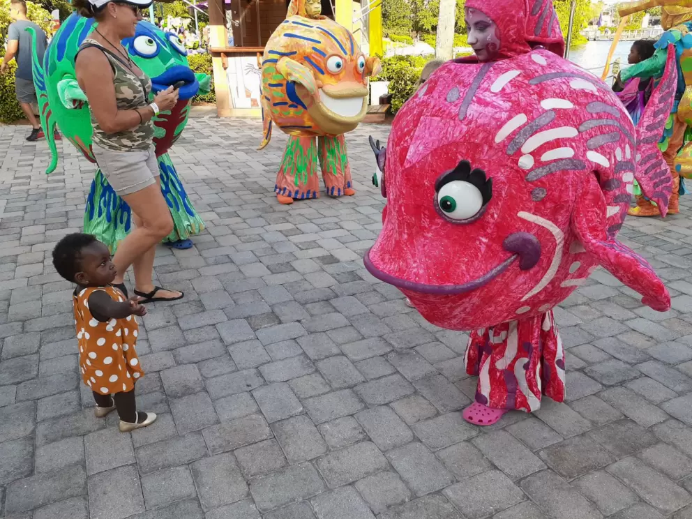 A child checks out a sea creature lady.