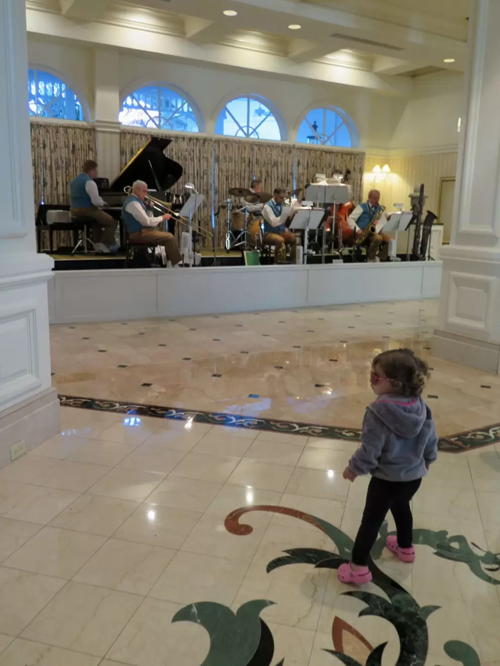 A toddler grooves to the jazz combo live music at the Grand Floridian (every afternoon).