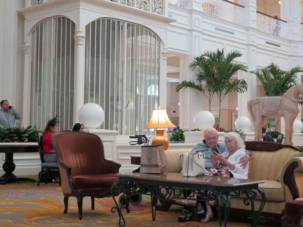A sweet couple listens to the live music in the lobby of the Grand Floridian.