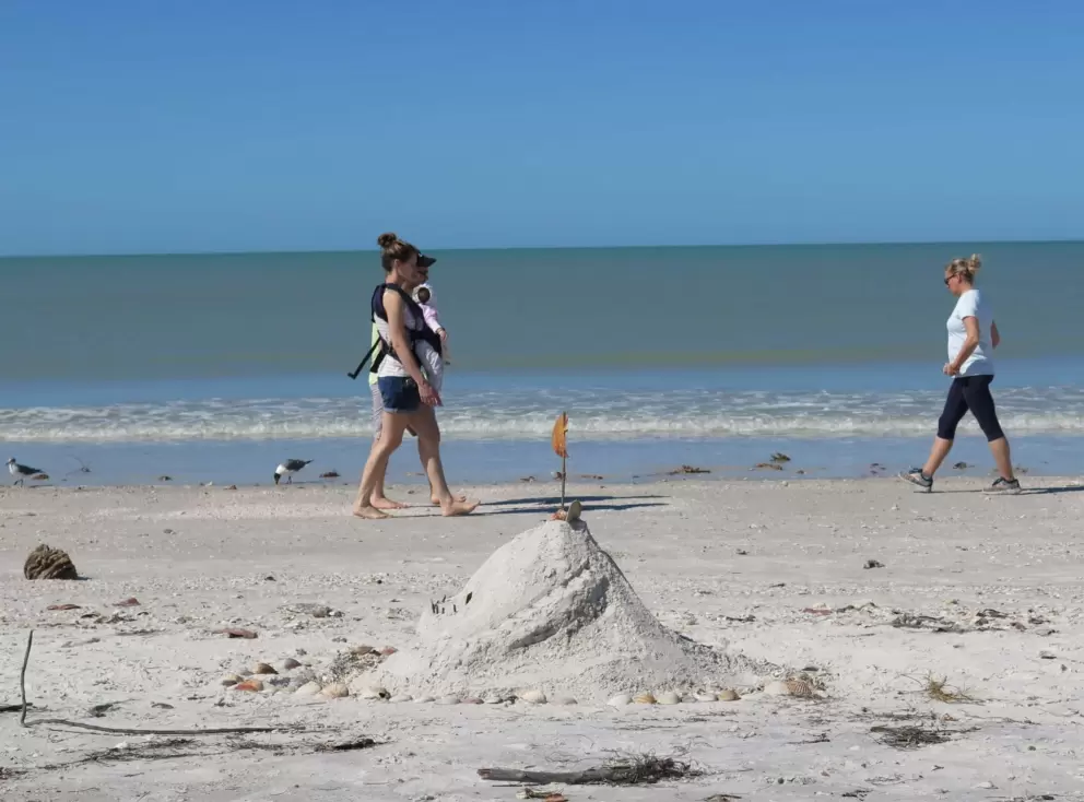 Sandcastle, and beach walkers.