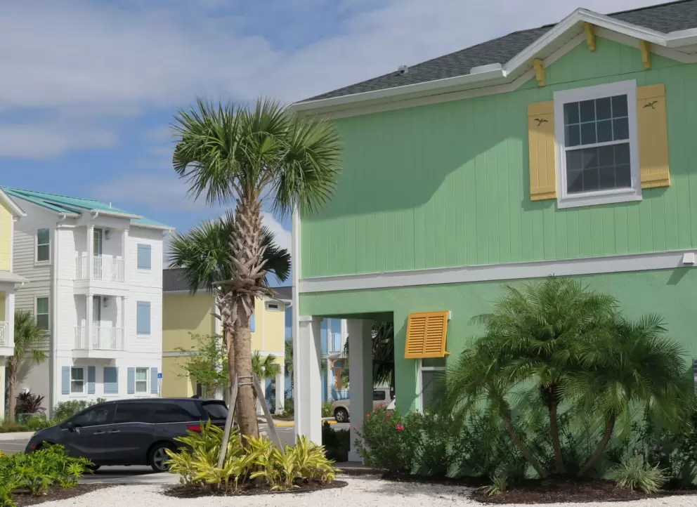 A green house and palms.