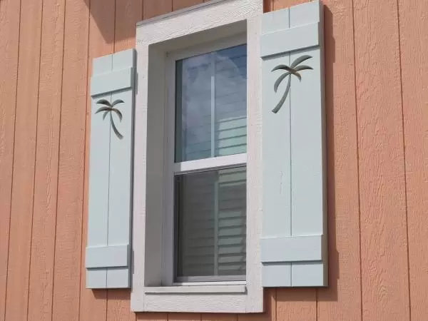 Palm tree cutouts in cottage shutters.