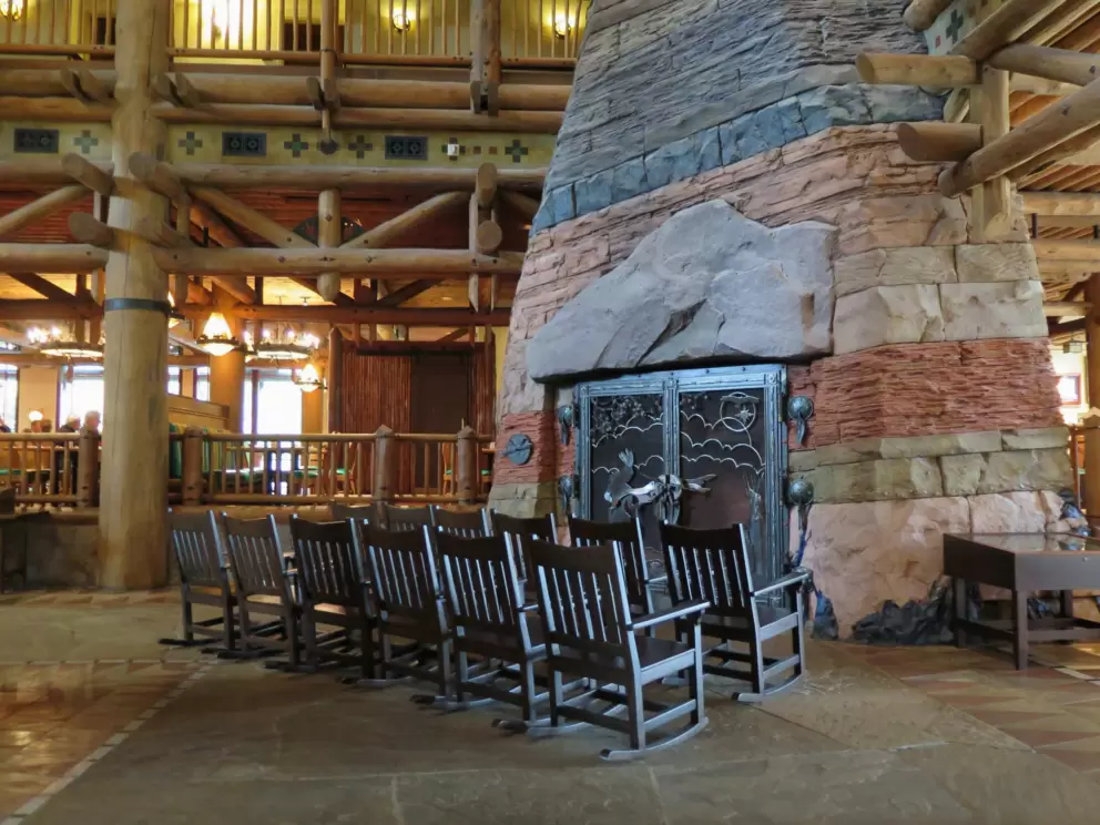Fireplace in the lobby, and rocking chairs.