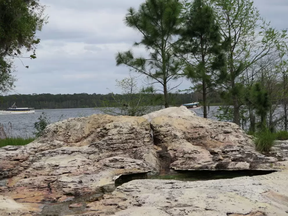 Rocks where a geyser spurts out, and lake.