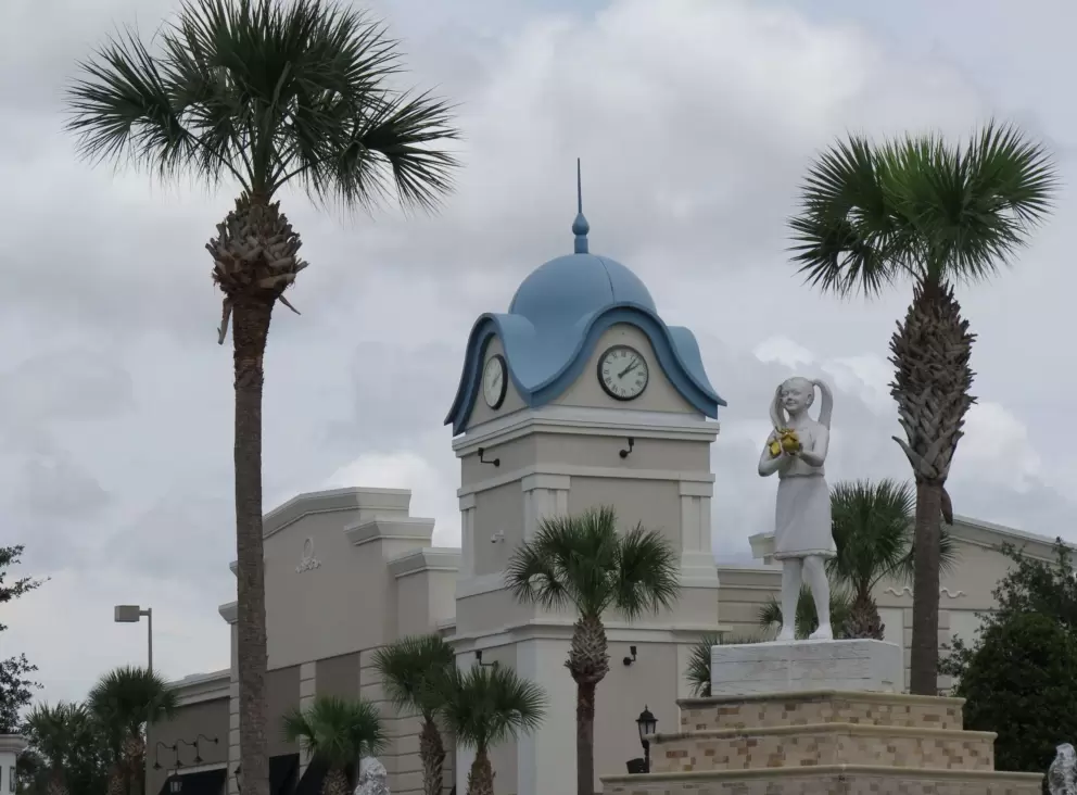 A sculpture of a girl in piggy tails, plus a blue clock tower.