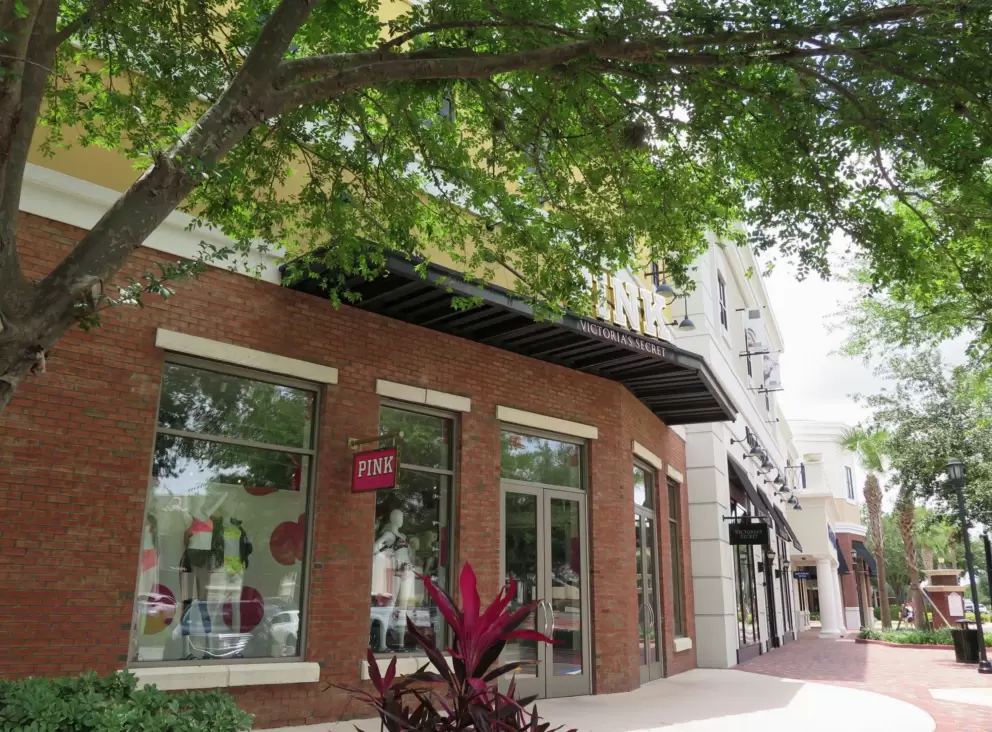 Stores with big windows, and plenty of shade in the walkway.