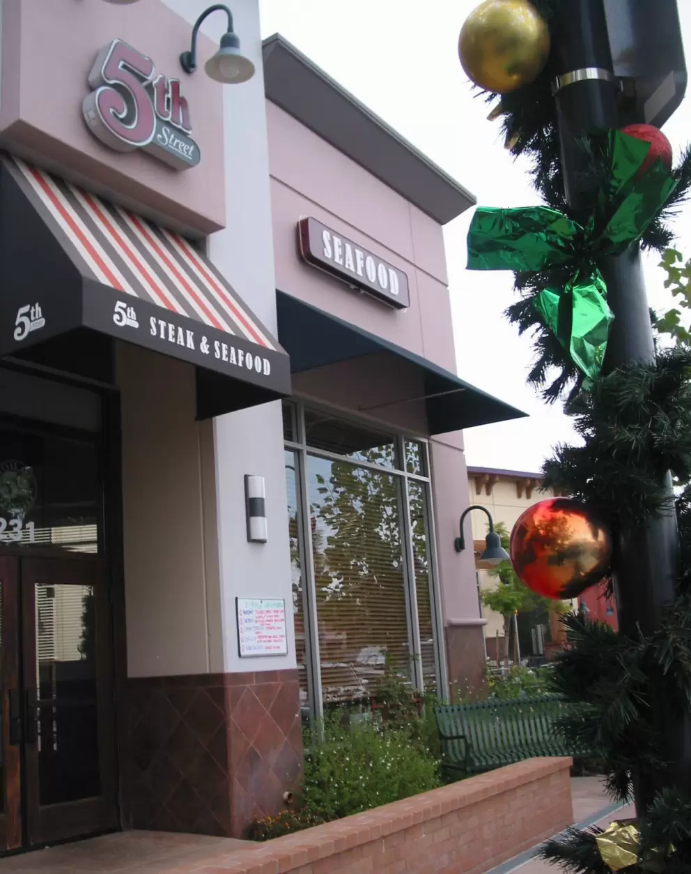 Christmas decorations and 5th Street Steakhouse, at Centennial Plaza. 