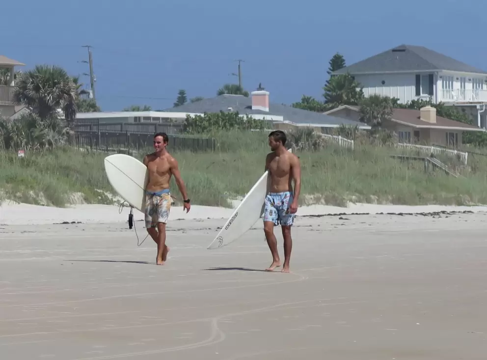 Surfers walking to the waves.