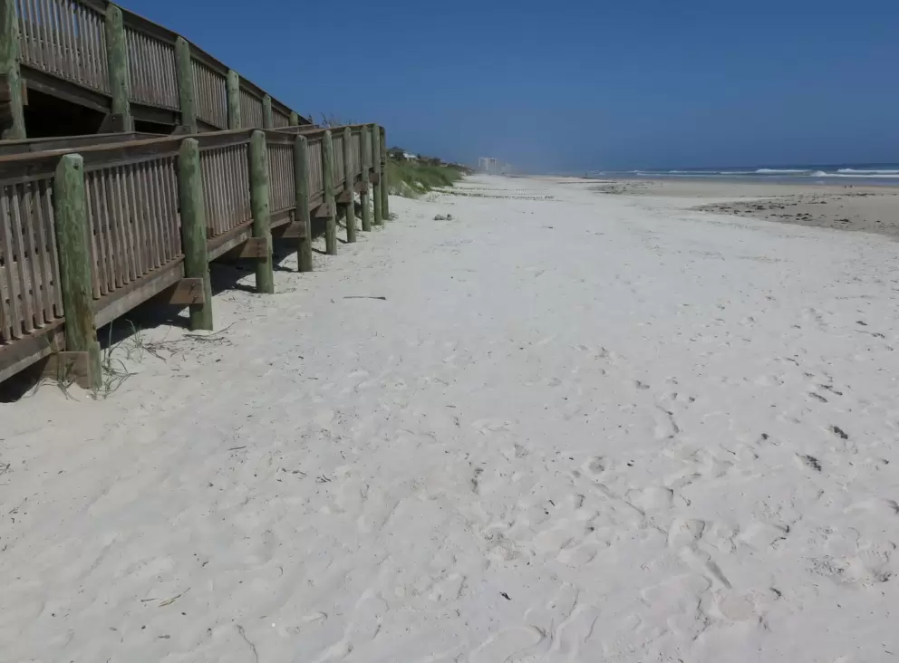 White sand by the boardwalk entrance.