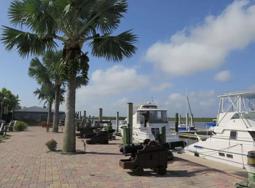 Cannons and fishing boats on a sunny day.