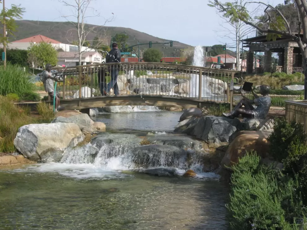 A bridge over a bubbling "creek"- fun for toddlers to stand and peer through the railings.