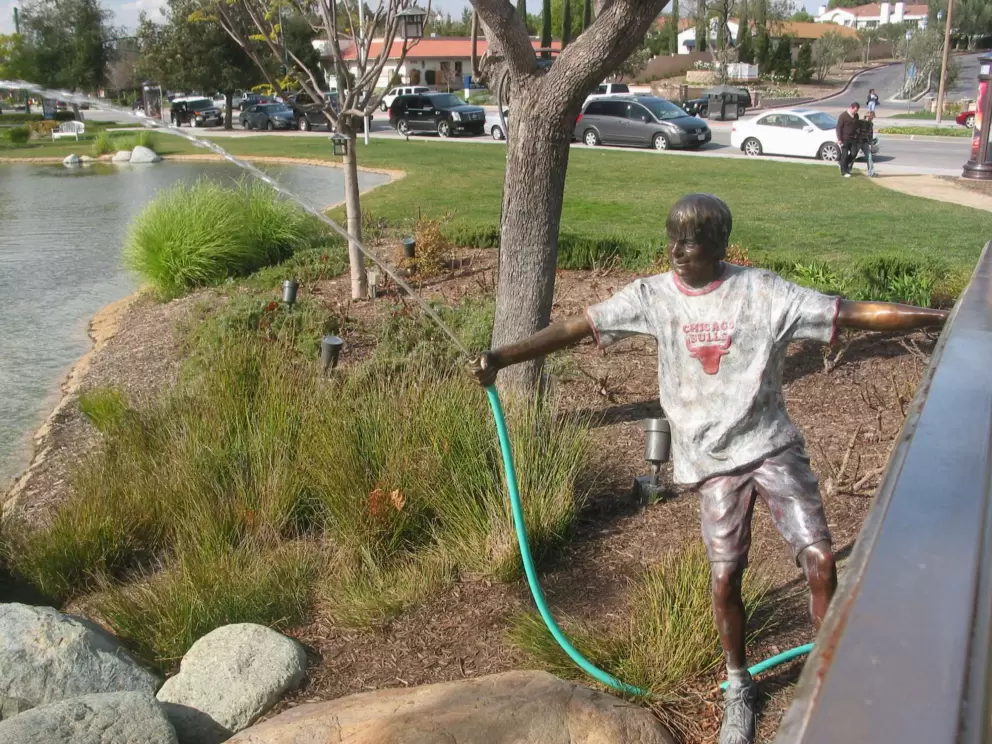The cool statue/fountain of boy with garden hose!