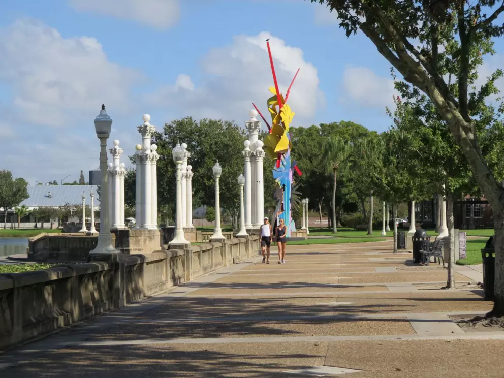 Sculpture and two women walking.