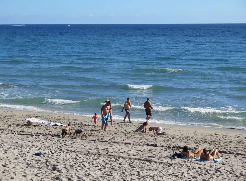People enjoying the beach on a December day.