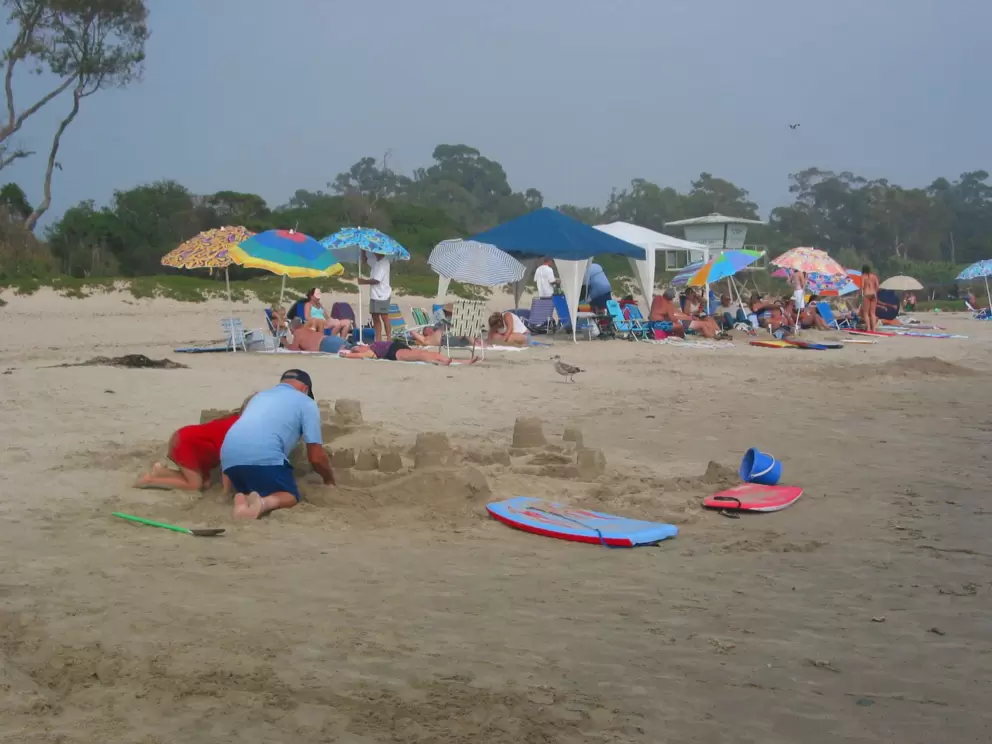 Rows of beach umbrellas and rows of sandcastles!