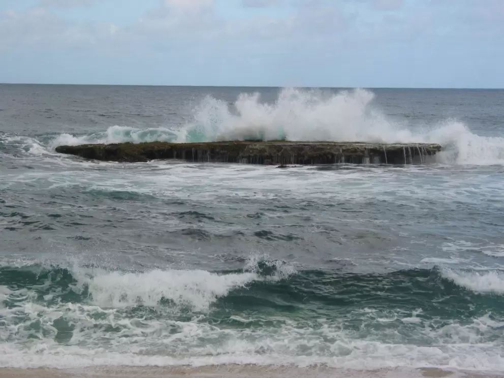 Water crashing on one of the "three tables."