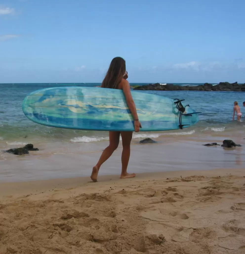 A surfer girl at Laniakea Beach.