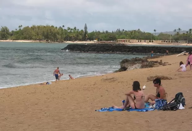Hanging out at Haleiwa Alii Beach- see the jetty for Haleiwa Harbor in the background.