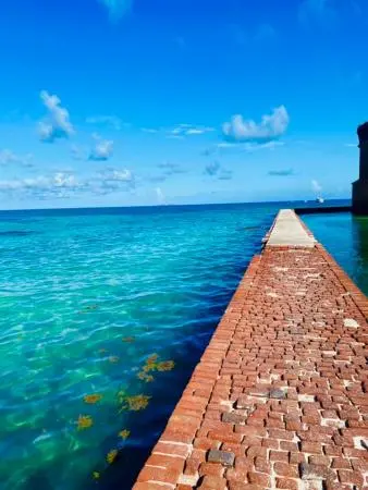 Views of the crystal clear water from the brick walkway.