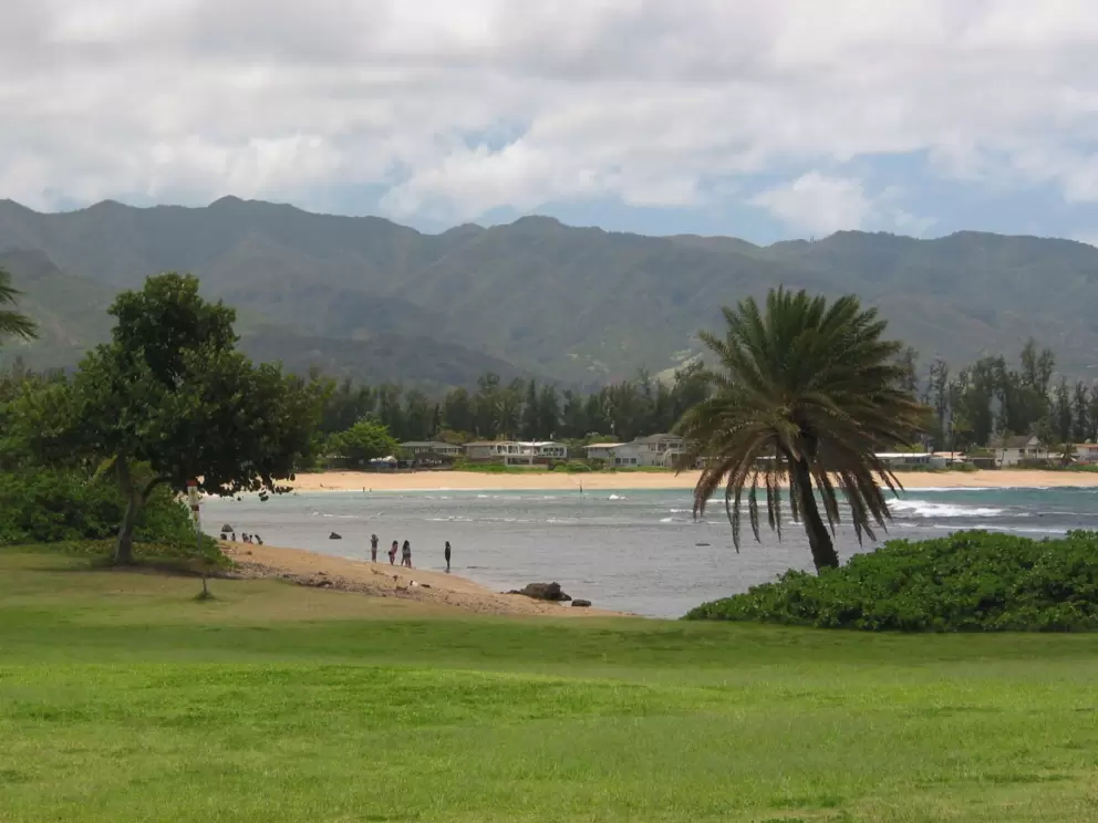 Walk west across the greenest lawn to another pretty beach.