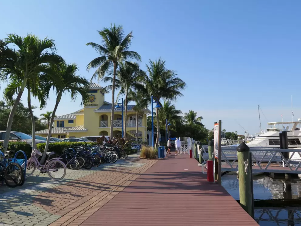 The glorious boardwalk, bikes, docks, boats, and the yellow Sunset Bay Marina building.