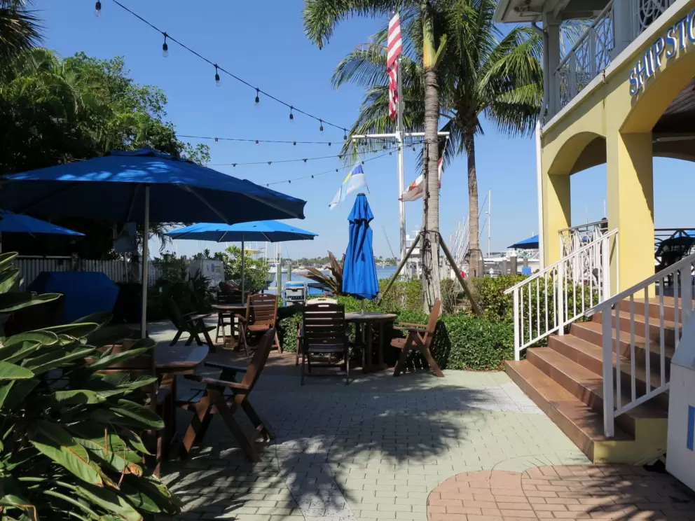 Shady side area with tables, at Gilbert's Coffee Bar.