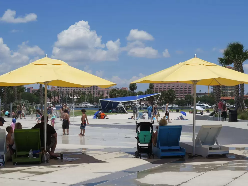 Yellow umbrellas and chairs at the splash pad.