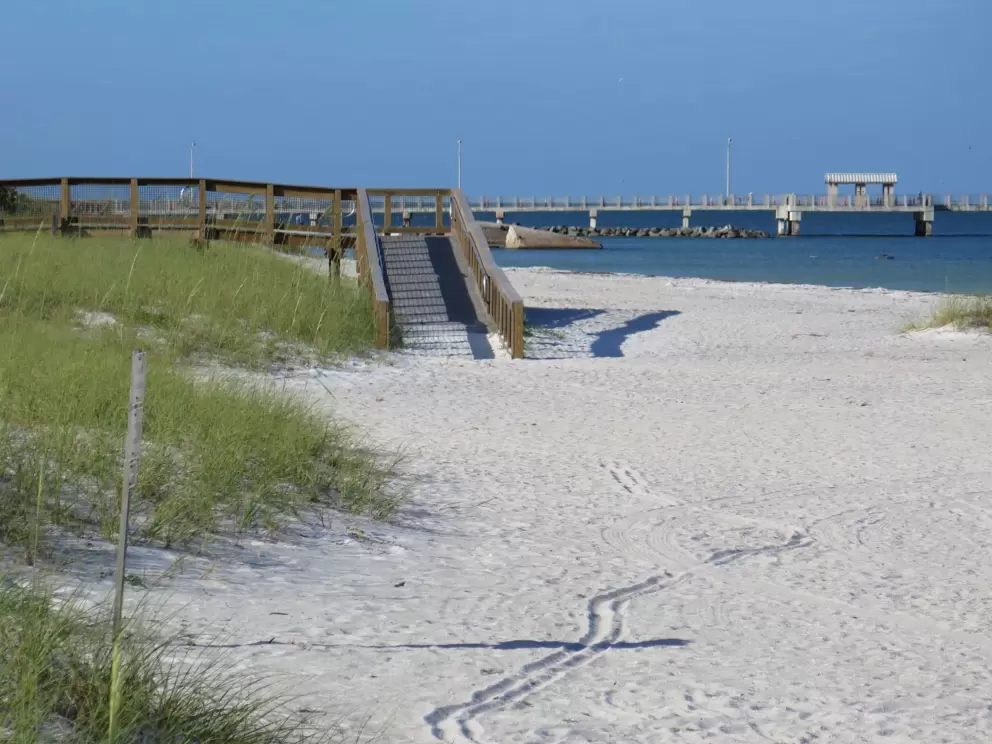 The wooden boardwalk to the sand, and the pier.