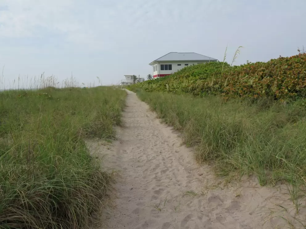 Sandy path to a lifeguard shack.