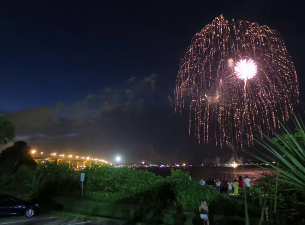 Cascading fireworks over the intracoastal, and the golden lights of the bridge in the distance.