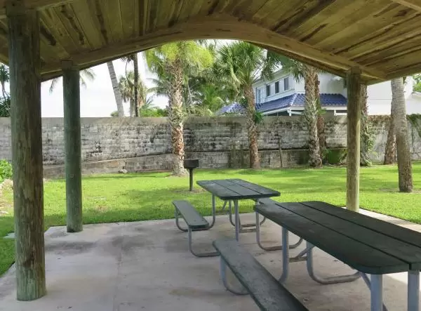 Picnic tables, BBQ, and grass.