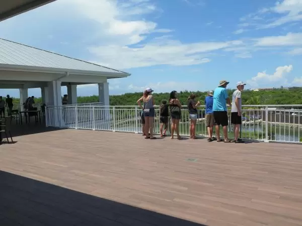 A family enjoys the awesome deck at the top of the large building.