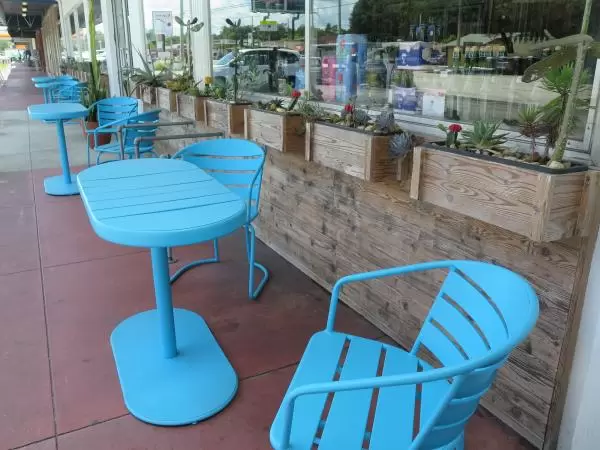 Seating outside Redlight Redlight, with cute cactus planters.