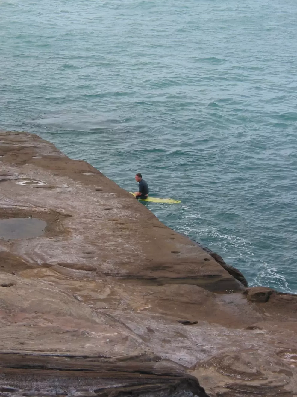 A surfer hangs out.