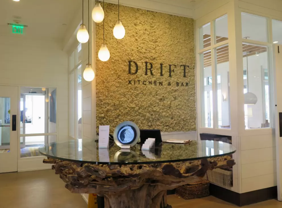 The entrance to Drift Kitchen with its teardrop lights and driftwood table.
